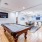 a room with a pool table and chairs