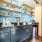 a kitchen with a shelf and cupboards