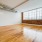 a room with a wood floor and a window