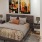 a bedroom with a large painting on the wall